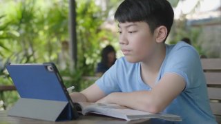 A boy reads online.