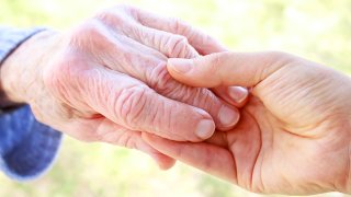 Senior and Young Women Holding Hands