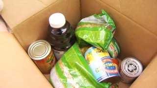 Assorted non-perishable food items in a box