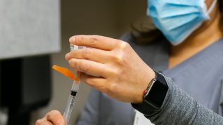 Picture of a nurse with a COVID-19 vaccine.