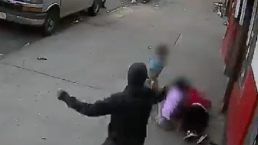 Video released by police shows an armed suspect chase after a man and shoot him inches away from two children.