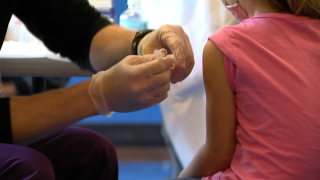 A Worcester student getting vaccinated at a school clinic on Monday, Nov. 8, 2021.