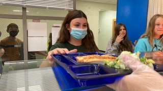 Students get lunch of homemade pizza and caesar salad at the Albert D. Lawton Intermediate School,