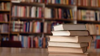 FILE- Close up of books on desk in library.