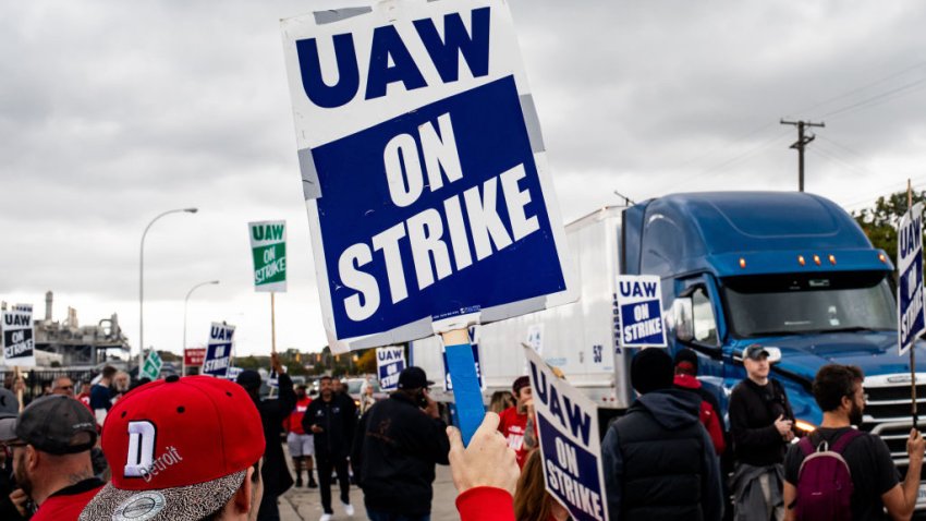 United Auto Workers (UAW) members and supporters attempt to block a truck from entering the Ford Motor Co. Michigan Assembly plant at a picket line in Wayne, Michigan, US, on Tuesday, Sept. 26, 2023. President Joe Biden endorsed the United Auto Workers’ demand for a major wage increase during a visit to a picket line at a General Motors Co. plant in suburban Detroit, a historic show of solidarity with organized labor. Photographer: Emily Elconin/Bloomberg via Getty Images