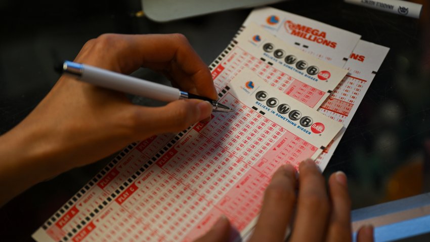 A person plays lottery at a store as US Powerball jackpot grand prize grew to a whopping $1 billion after no ticket got all six numbers.