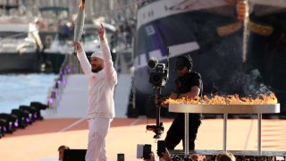 El rapero francés Julien Mari, alias 'Jul', sostiene la llama olímpica durante la ceremonia de llegada de la llama olímpica antes de los Juegos Olímpicos de París 2024 el 8 de mayo de 2024 en Marsella, Francia.