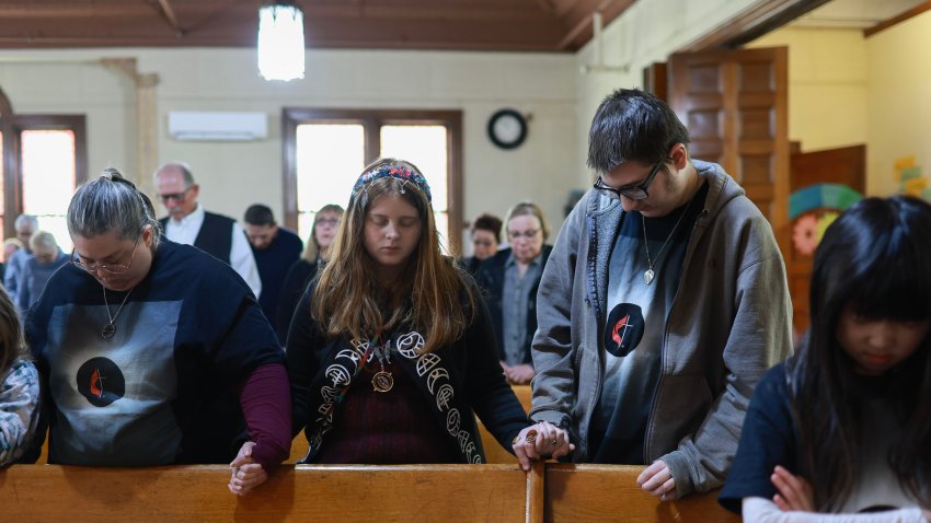 HOULTON, MAINE – APRIL 07: (L-R) Isabella Alexander, Erica Alexander, Mallory Alexander, and Joey Alexander pray together during a mass held at the Houlton United Methodist Church on April 07, 2024, in Houlton, Maine. During the mass, Pastor Victor Han spoke to the congregation about the coming eclipse. Millions of people have flocked to areas across North America that are in the “path of totality” in order to experience a total solar eclipse. During the event, the moon will pass in between the sun and the Earth, appearing to block the sun. (Photo by Joe Raedle/Getty Images)