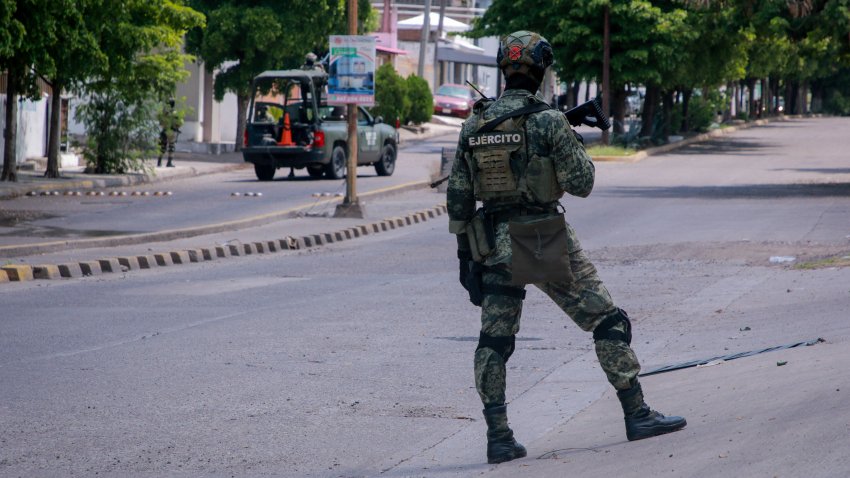 EDITORS NOTE: Graphic content / A member of the Mexican Army stands guard after an armed attack against the facade of a business selling new and pre-owned cars in Culiac√°n, Sinaloa State, Mexico, on September 12, 2024. Spiraling criminal violence, much of it linked to drug trafficking and gangs, has seen more than 450,000 people murdered in Mexico since 2006. (Photo by Ivan MEDINA / AFP) (Photo by IVAN MEDINA/AFP via Getty Images)