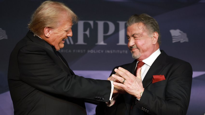 PALM BEACH, FLORIDA – NOVEMBER 14: U.S. President-elect Donald Trump greets actor Sylvester Stallone onstage at the America First Policy Institute Gala held at Mar-a-Lago on November 14, 2024 in Palm Beach, Florida. The annual event supports Grey Team, a nonprofit organization dedicated to preventing military suicide. (Photo by Joe Raedle/Getty Images)