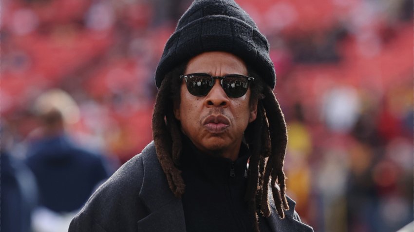 LANDOVER, MARYLAND – NOVEMBER 24: Rapper Jay-Z (C) looks on before a game between the Washington Commanders and the Dallas Cowboys at Northwest Stadium on November 24, 2024 in Landover, Maryland. (Photo by Timothy Nwachukwu/Getty Images)