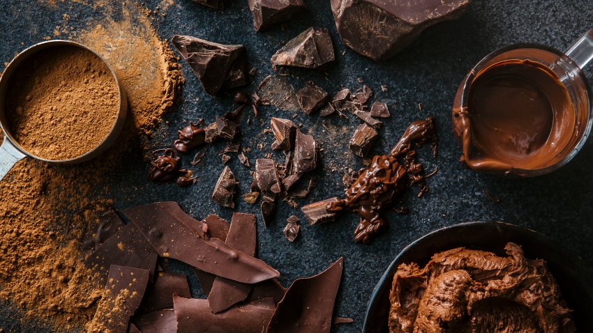 overhead view of chocolate chunks, chocolate frosting and cocoa,