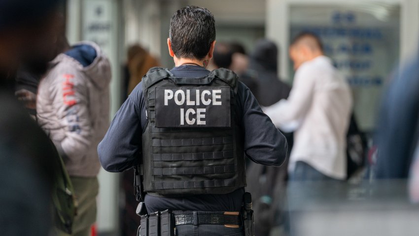 NEW YORK, NEW YORK – JUNE 6: An ICE agent monitors hundreds of asylum seekers being processed upon entering the Jacob K. Javits Federal Building on June 6, 2023 in New York City. New York City has provided sanctuary to over 46,000 asylum seekers since 2013, when the city passed a law prohibiting city agencies from cooperating with federal immigration enforcement agencies unless there is a warrant for the person’s arrest.(Photo by David Dee Delgado/Getty Images)