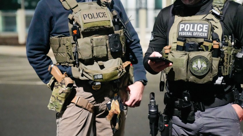 WASHINGTON, DC – FEBRUARY 4: In this handout photo provided by U.S. Immigration and Customs Enforcement, two federal law enforcement officers coordinate with other officials on the ground during an enhanced immigration enforcement operation on February 4, 2025 near Washington, D.C. (Photo by U.S. Immigration and Customs Enforcement via Getty Images)
