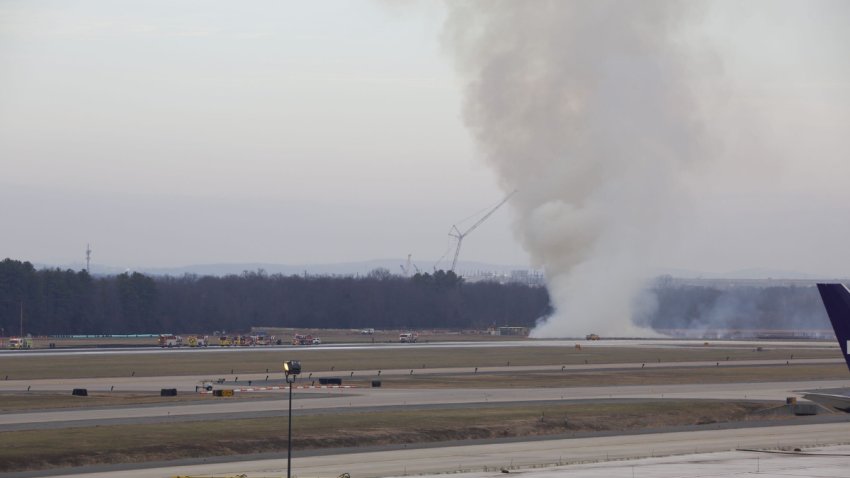 Smoke seen at Dulles International Airport after a plane engine failed during a United flight’s takeoff en route to Tokyo, Japan on Dec. 13, 2025. The engine failure sparked a brush fire near the runway.