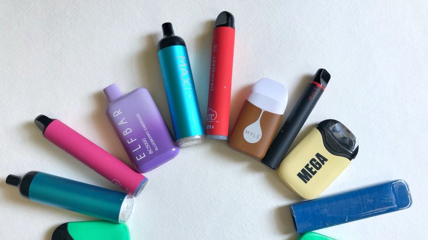 Group of used or discarded Vape Pens found littering the streets in New York City, arranged in an arch.